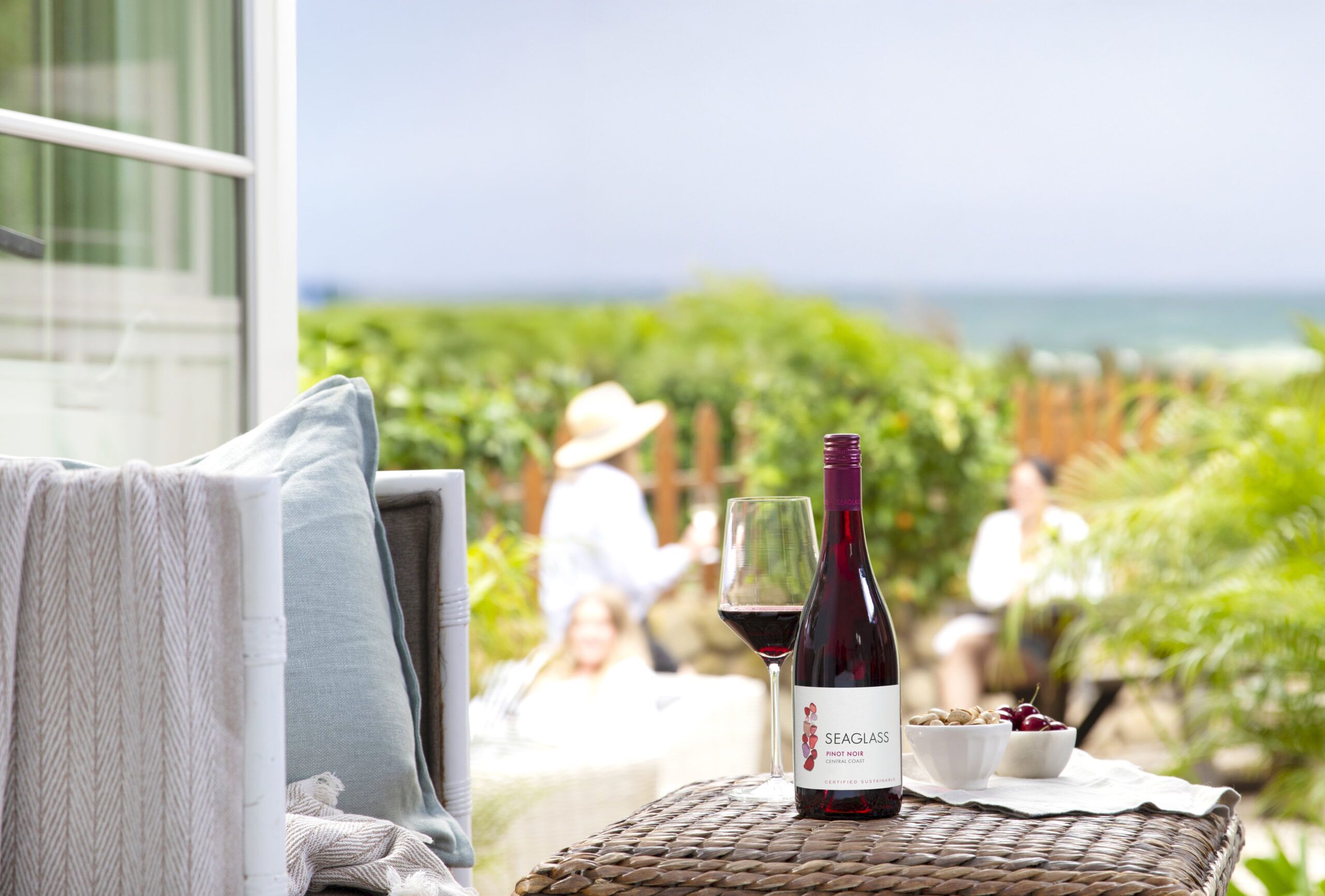 SEAGLASS Pinot Noir bottle on table next to the beach