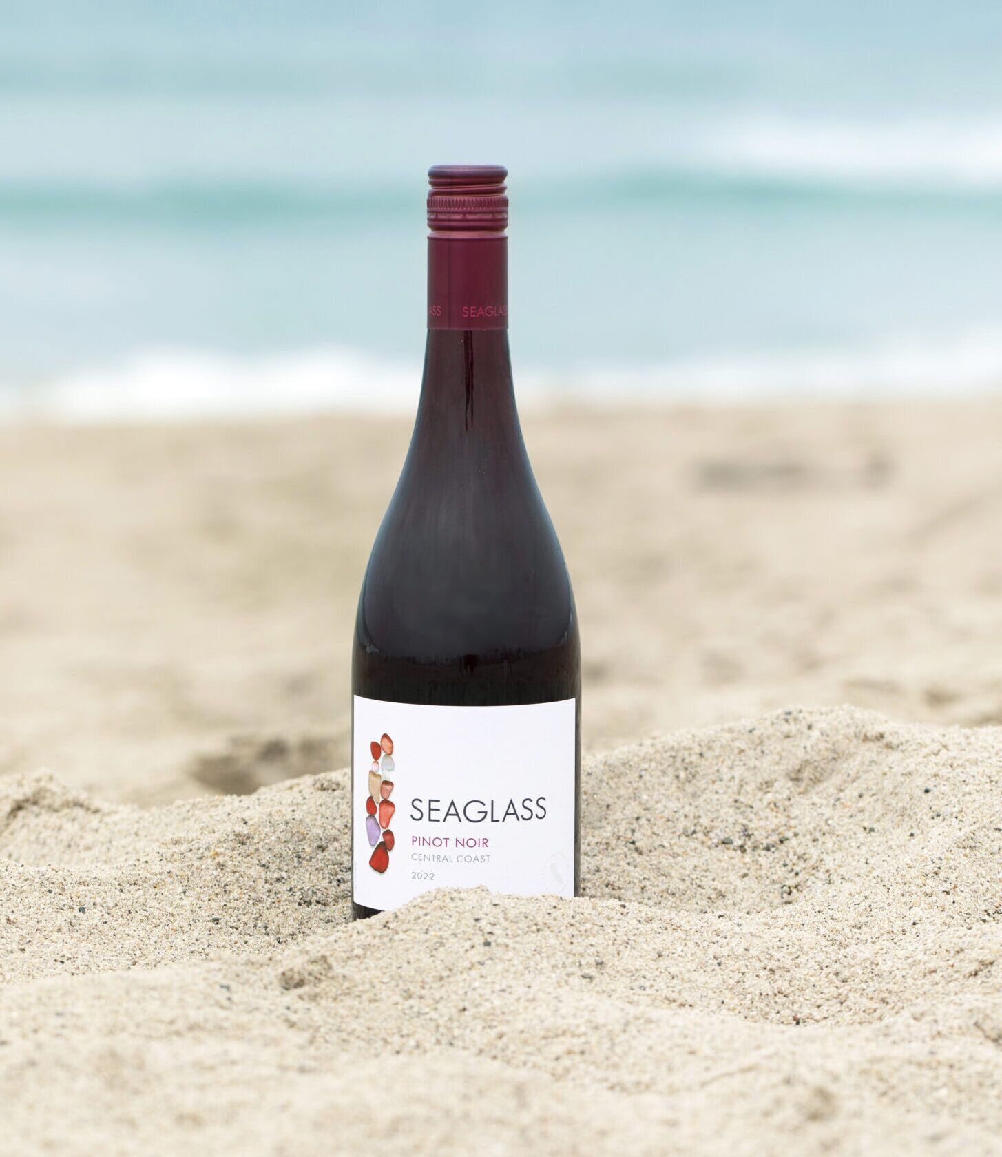 SEAGLASS Pinot Noir bottle in sand