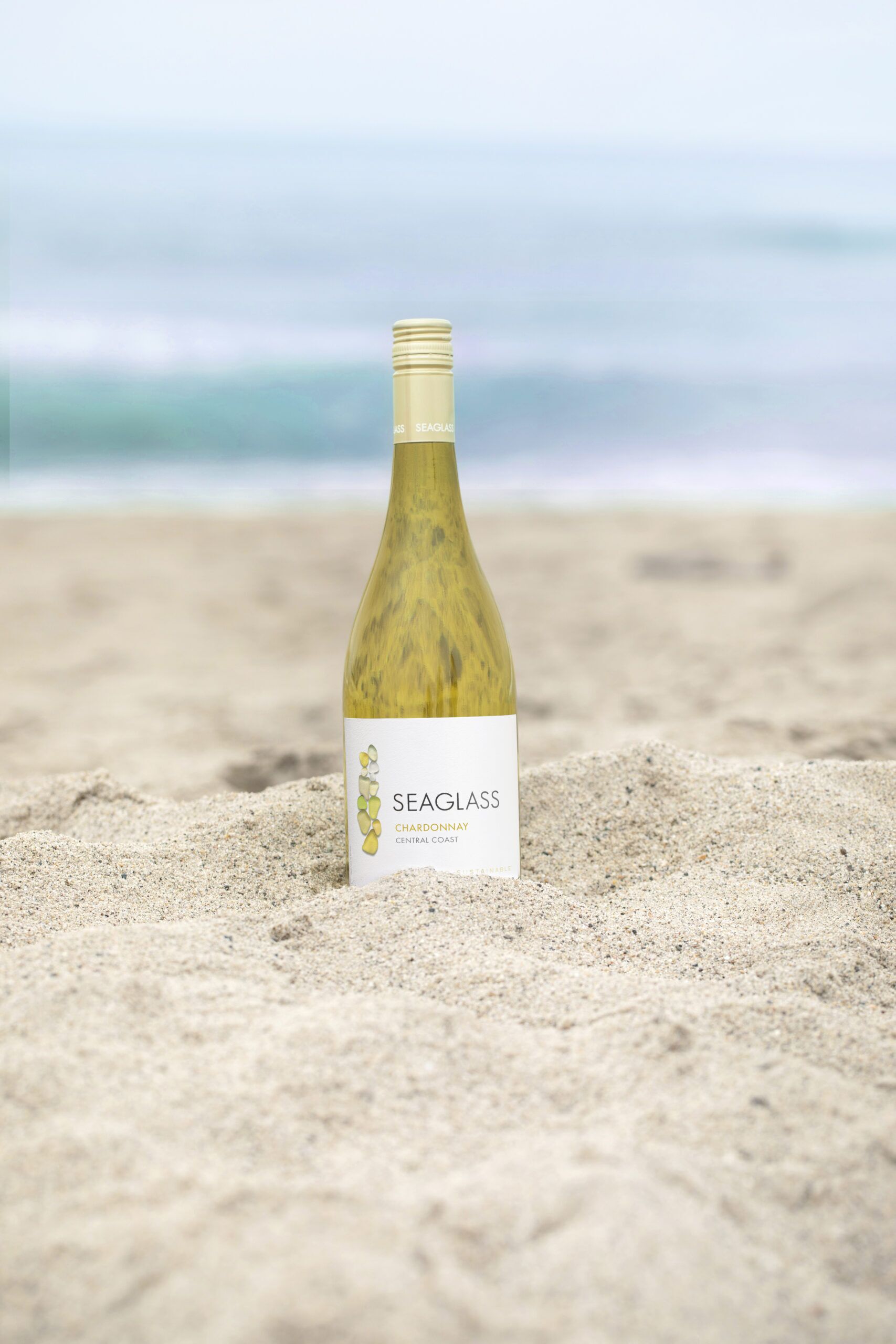 SEAGLASS Chardonnay bottle in sand