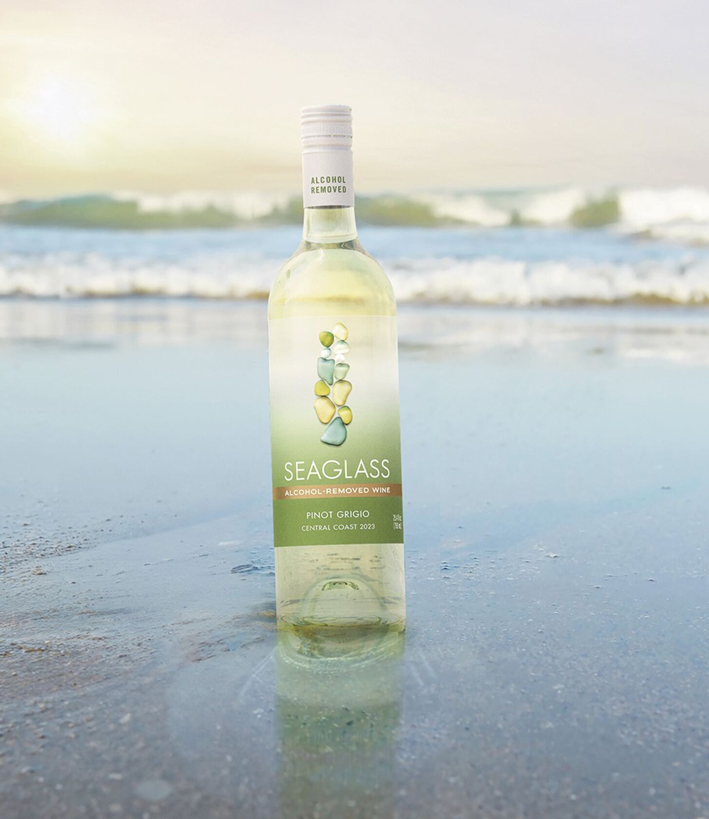 SEAGLASS Alcohol-Removed Pinot Grigio bottle in sand