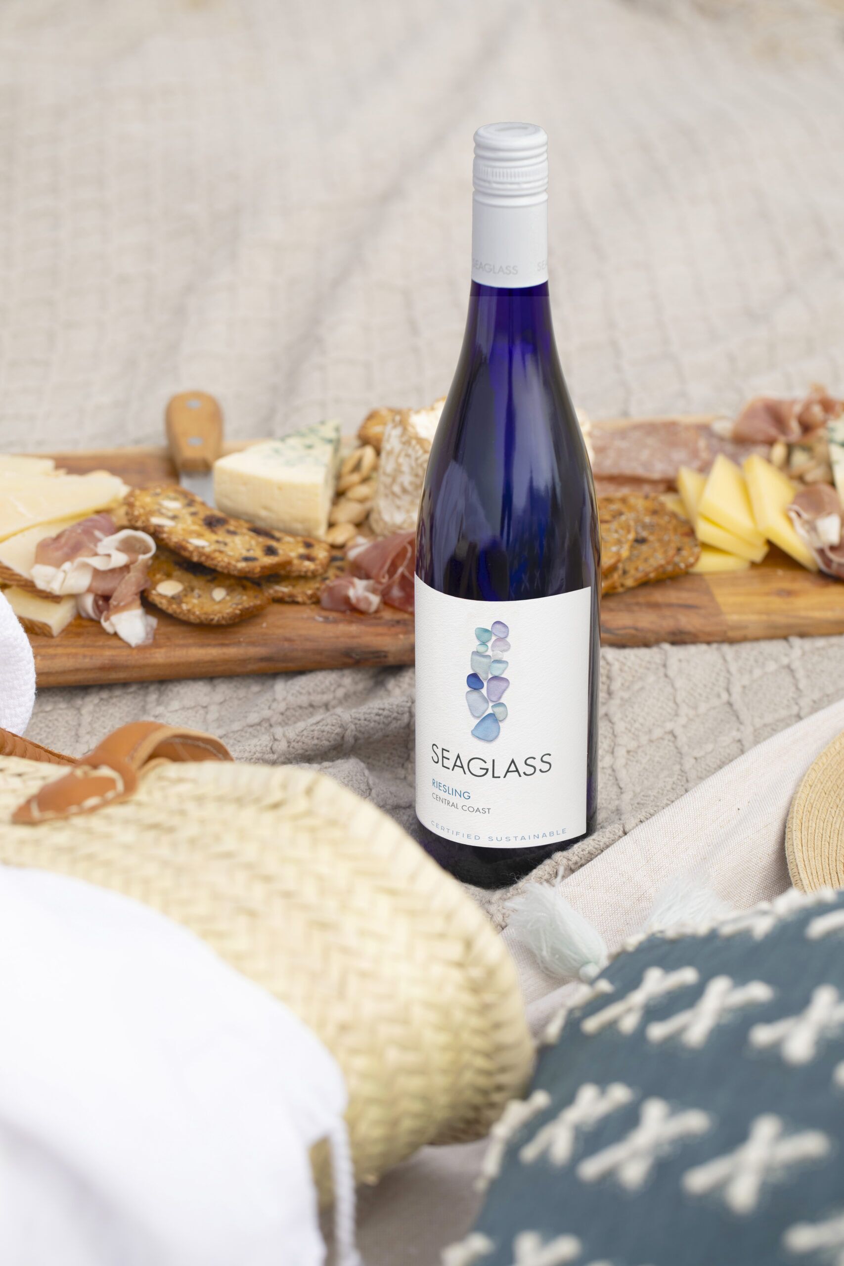 SEAGLASS Riesling bottle next to charcuterie board