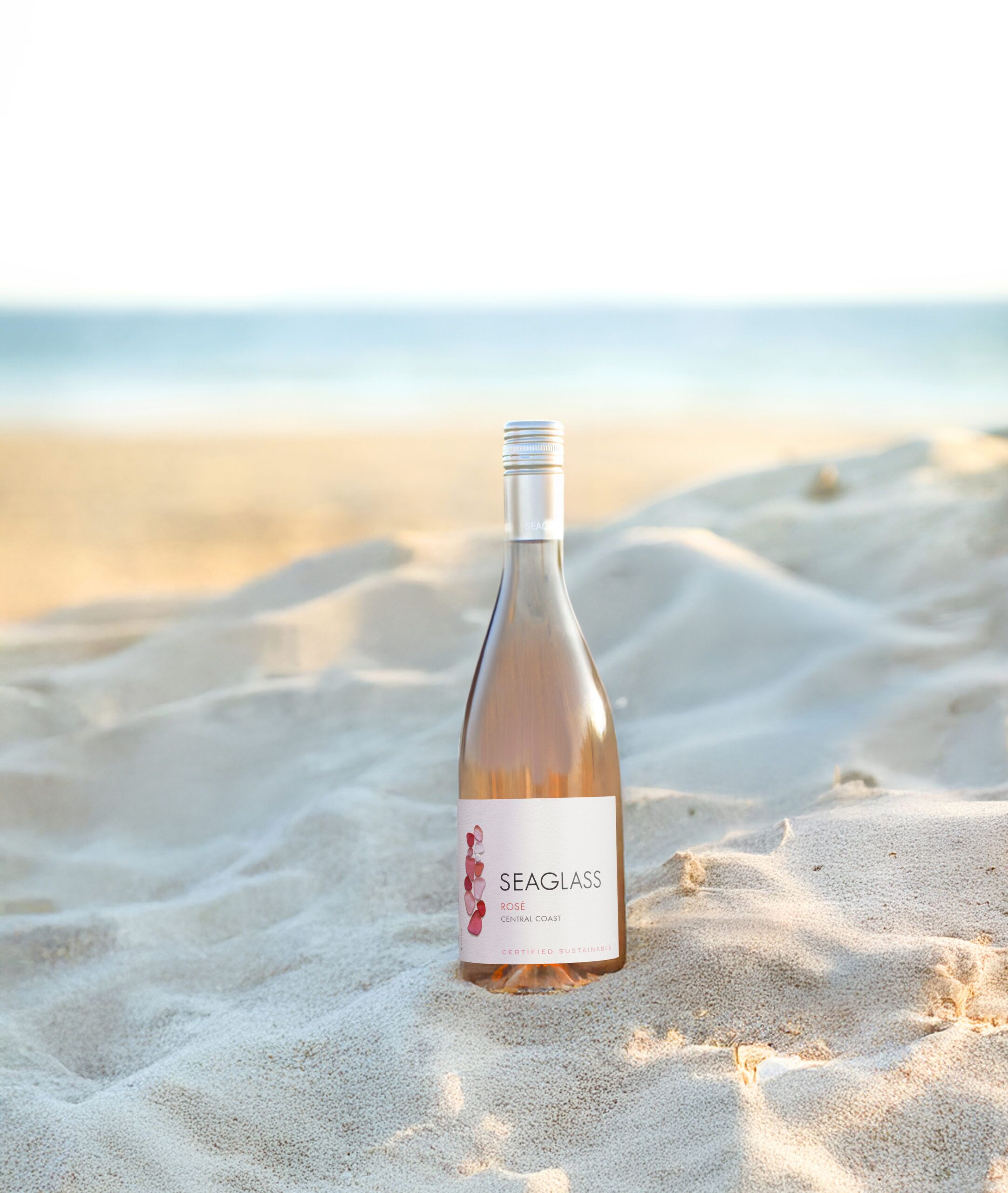 SEAGLASS Rose bottle in sand