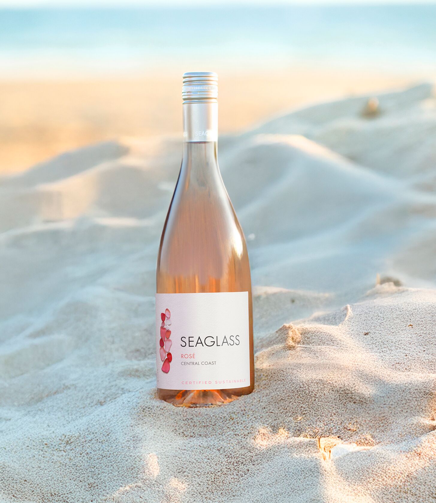 SEAGLASS Rose bottle in sand