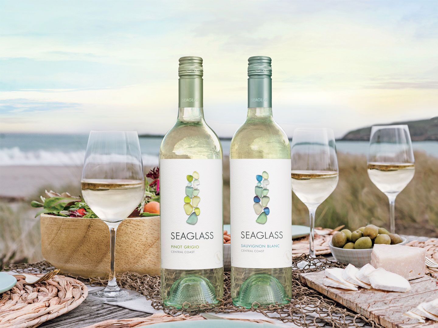 Bottles of Seaglass white wine with a scenic coastal view in the backround